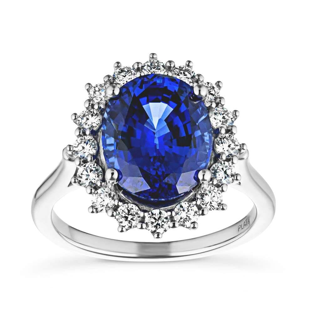 Shown with 3ct Oval Cut Lab Grown Blue Sapphire in 14k White Gold|Vintage style engagement ring with floral design halo around a 3ct lab created blue sapphire in 14k white gold