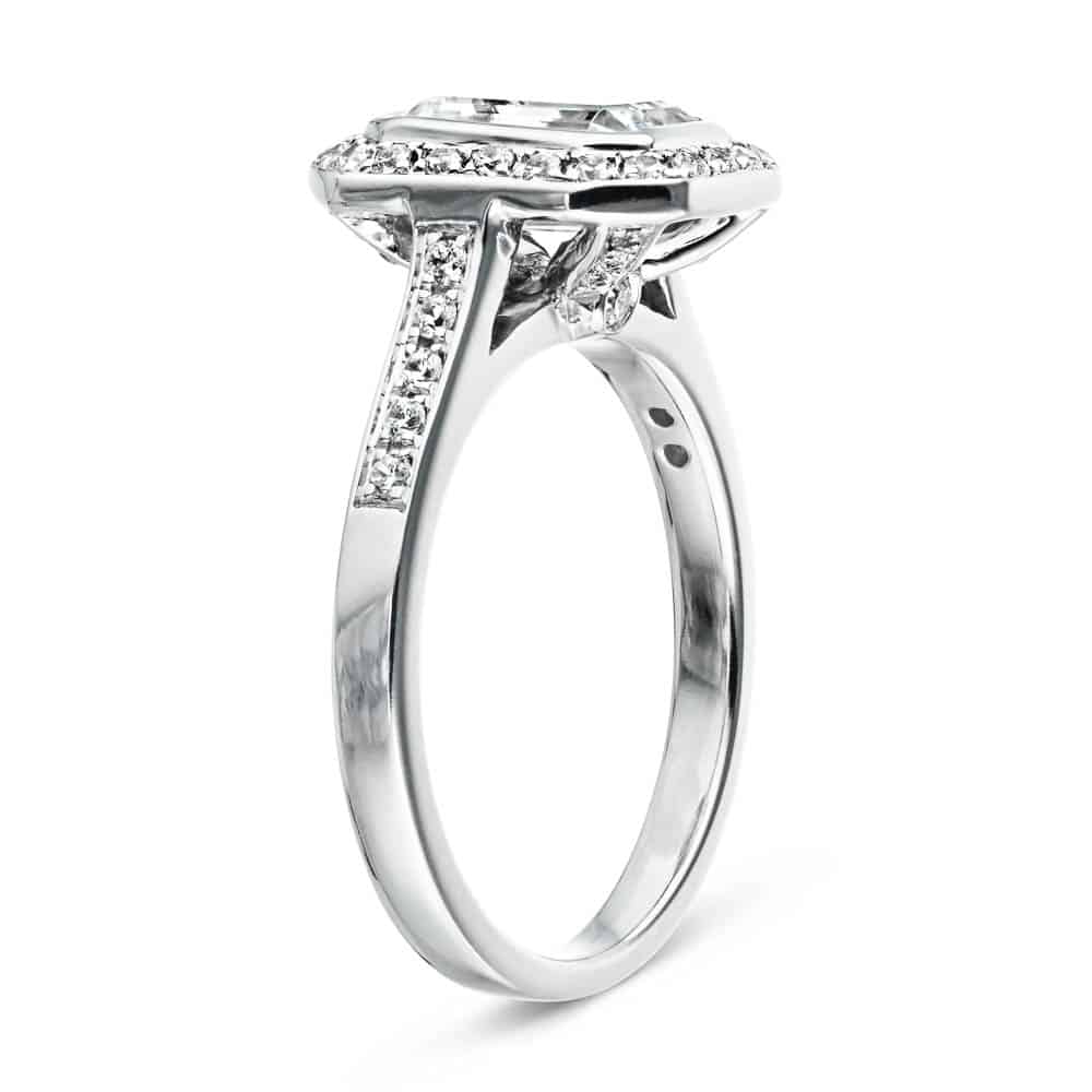 Shown with 1ct Emerald Cut Lab Grown Diamond in 14k White Gold|Antique style accented halo engagement ring with 1ct emerald cut lab grown diamond and peek-a-boo diamonds in 14k white gold shown from side