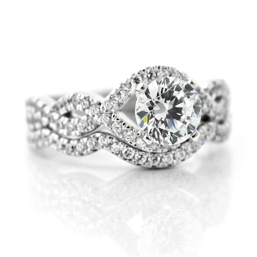 Shown with a 1.0ct Round cut Lab-Grown Diamond with infinity style diamond accented band with matching wedding band | wedding set Shown with a 1.0ct Round cut Lab-Grown Diamond with infinity style diamond accented band with matching wedding band