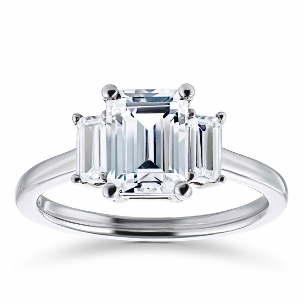 Shown with 1.75ct Emerald Cut Lab Grown Diamond in 14 White Gold|Beautiful three stone engagement ring with 1.75ct emerald cut lab grown diamond center stone and two baguette cut diamond side stones in 14k white gold