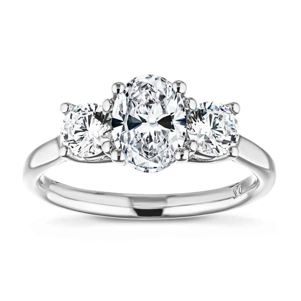 Shown with 1ct Oval Cut and Two 0.5ct Round Cut Lab Grown Diamonds in 14k White Gold|Beautiful three stone engagement ring with 1ct oval cut lab grown diamond and two 0.5ct round cut lab diamond side stones in 14k white gold