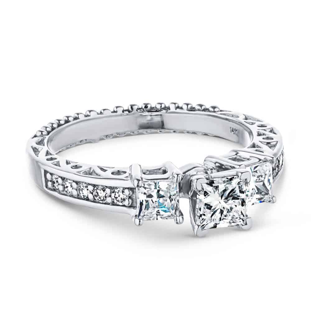 Shown with Three Princess Cut Lab Grown Diamonds Set in 14k White Gold|Vintage style three stone engagement ring with princess cut lab grown diamonds and antique style scroll detailing in 14k white gold