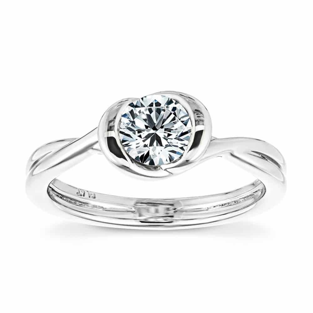Shown with 1ct Round Cut Lab Grown Diamond in Platinum|Minimalistic modern solitaire engagement ring with twisted band design holding a 1ct round cut lab grown diamond in platinum setting