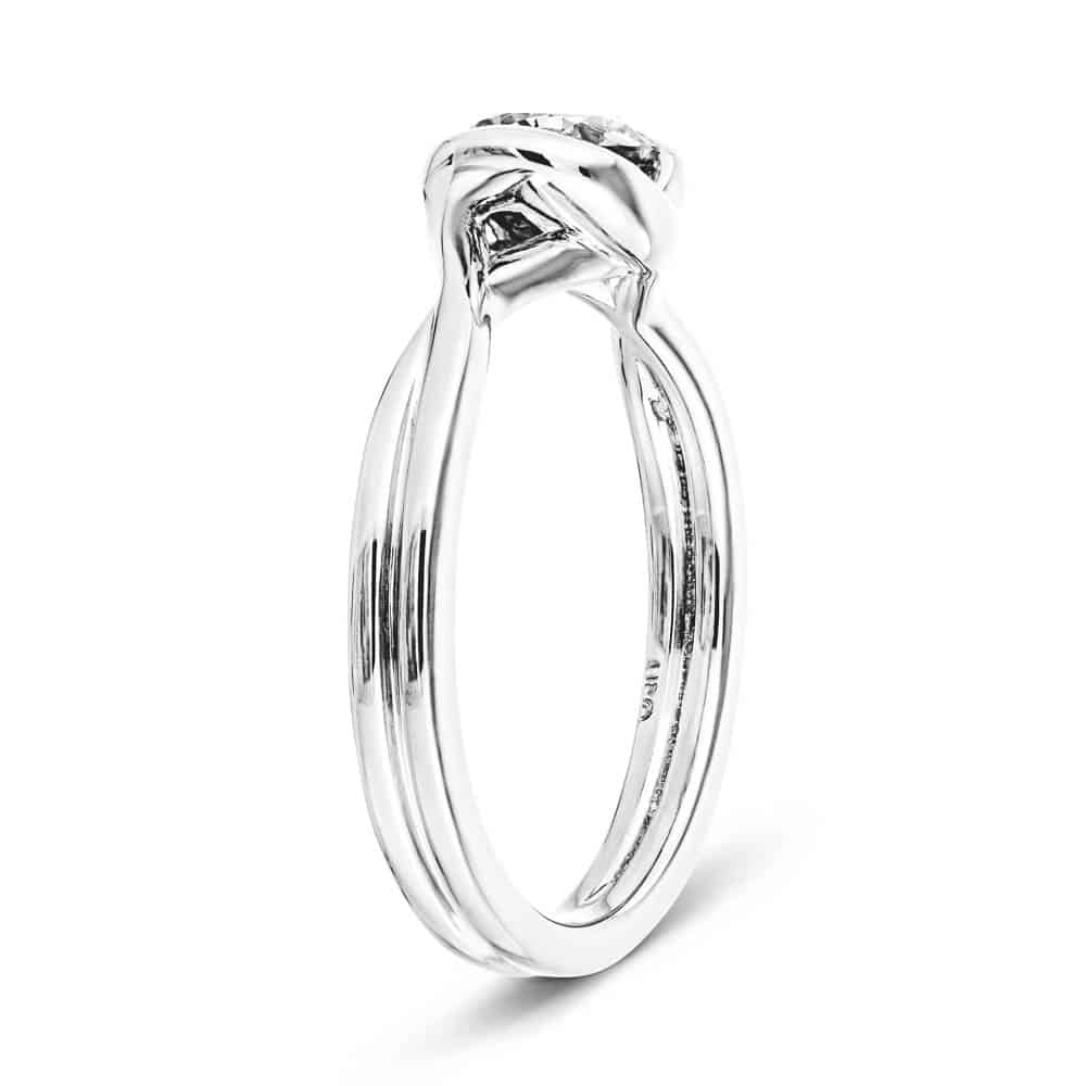 Shown with 1ct Round Cut Lab Grown Diamond in Platinum|Modern engagement ring with twisted band design holding a 1ct round cut lab grown diamond in platinum setting shown from side