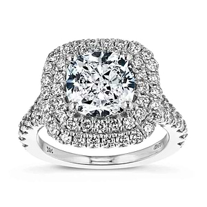 Stunning split shank double halo engagement ring with diamond accents featuring a 1ct cushion cut lab grown diamond in 14k white gold