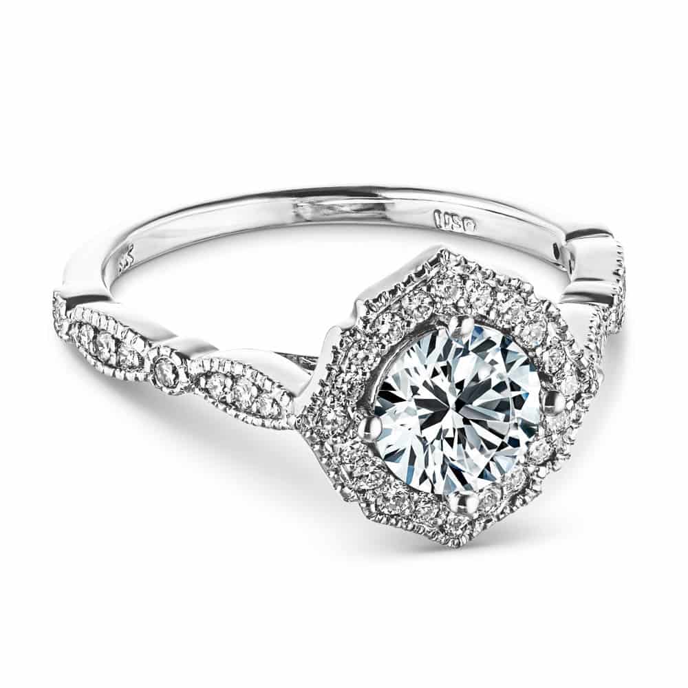 Shown with 1ct Round Cut Lab Grown Diamond in 14k White Gold|Vintage style engagement ring reminiscent of Paris featuring a diamond accented halo and band with filigree detailing holding a 1ct round cut diamond in 14k white gold