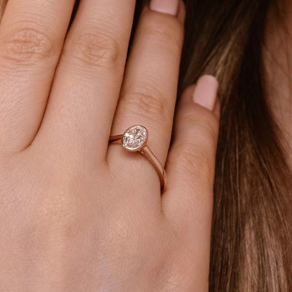 Shown In 14K Rose Gold With An Oval Cut Center Stone|bezel solitaire ring with an oval cut lab grown diamond center stone