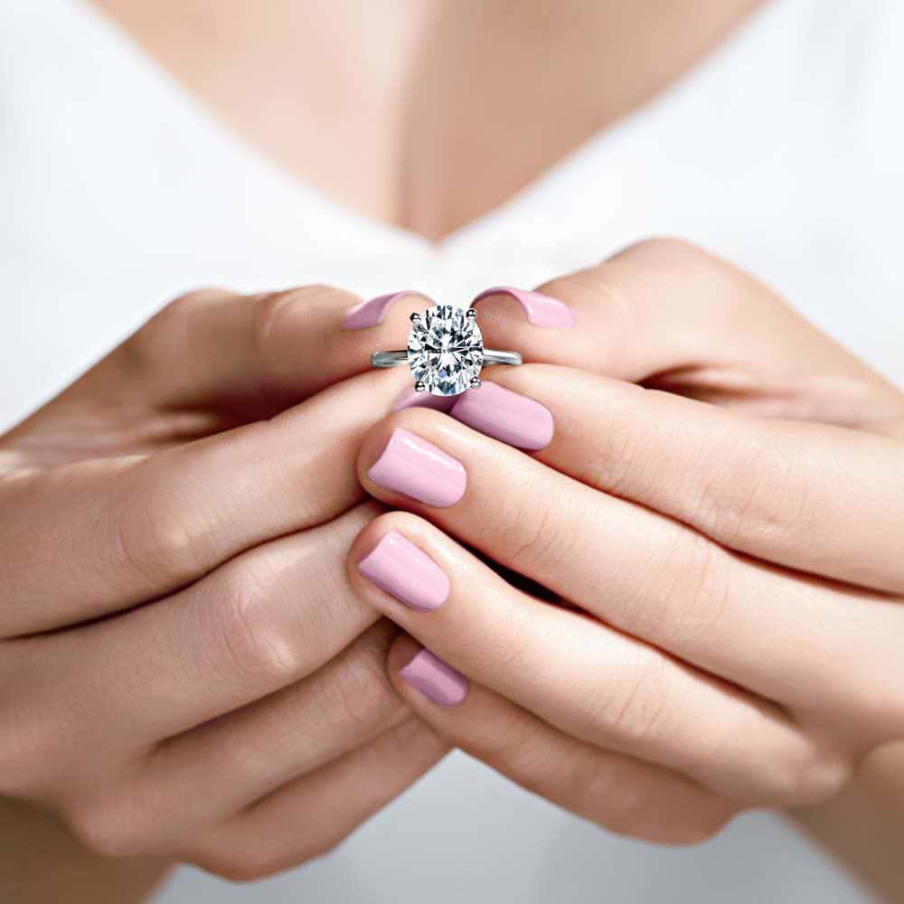 Shown In 14K White Gold With An Oval Cut Center Stone|hidden halo solitaire ring set with an oval cut lab grown diamond center stone