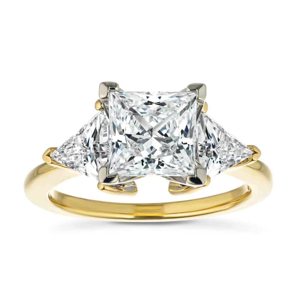 Shown with 1.5ct Princess Cut Lab Grown Diamond & 0.50ct Triangle Cut Side Stones in 14k Yellow Gold|Beautiful ethical three stone engagement ring with 1.5ct princess cut lab grown diamond and two 0.50 triangle cut diamond side stones in 14k yellow gold band
