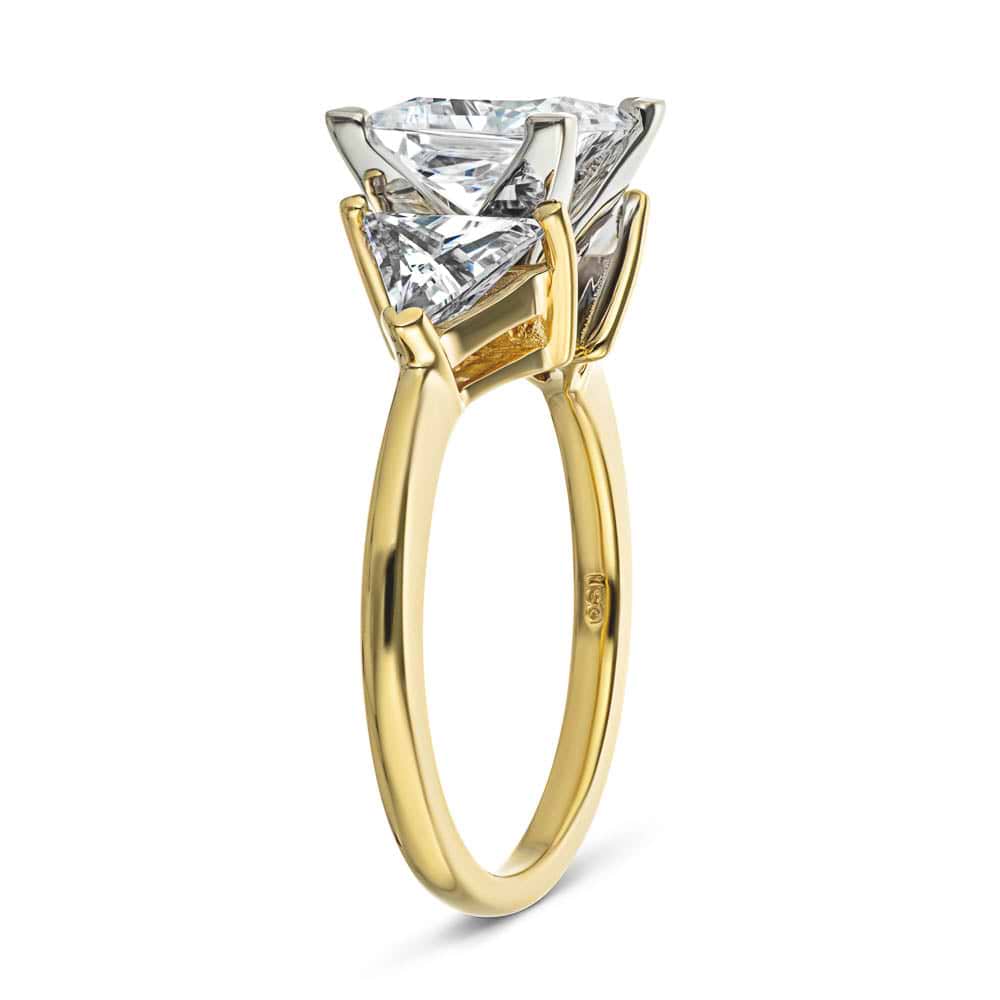 Shown with 1.5ct Princess Cut Lab Grown Diamond & 0.50ct Triangle Cut Side Stones in 14k Yellow Gold|Three stone engagement ring with 1.5ct princess cut lab grown diamond and two 0.50 triangle cut diamond side stones in 14k yellow gold shown from side