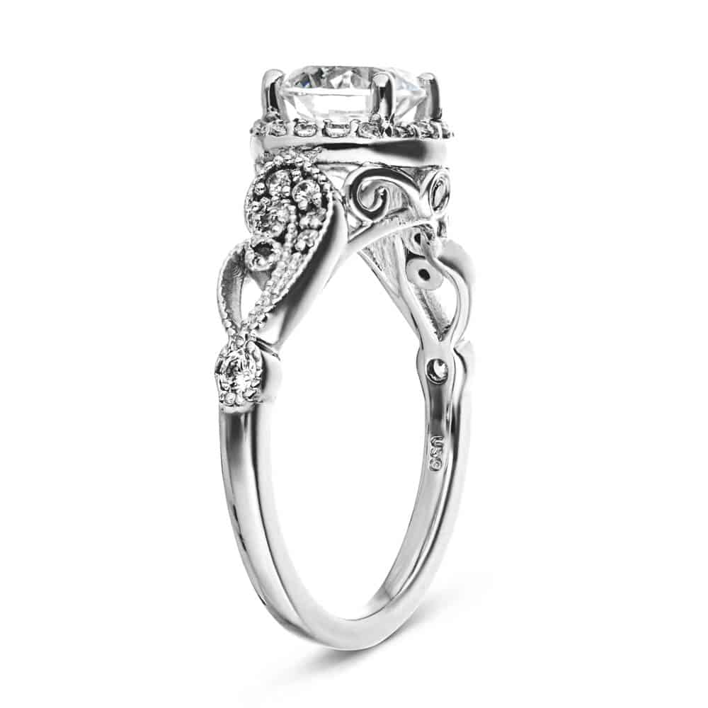 Shown with 1ct Round Cut Lab Grown Diamond in 14k White Gold|Vintage style diamond accented halo engagement ring with 1ct round cut lab created diamond with milgrain and filigree detailing in two tone 14k white gold shown from side