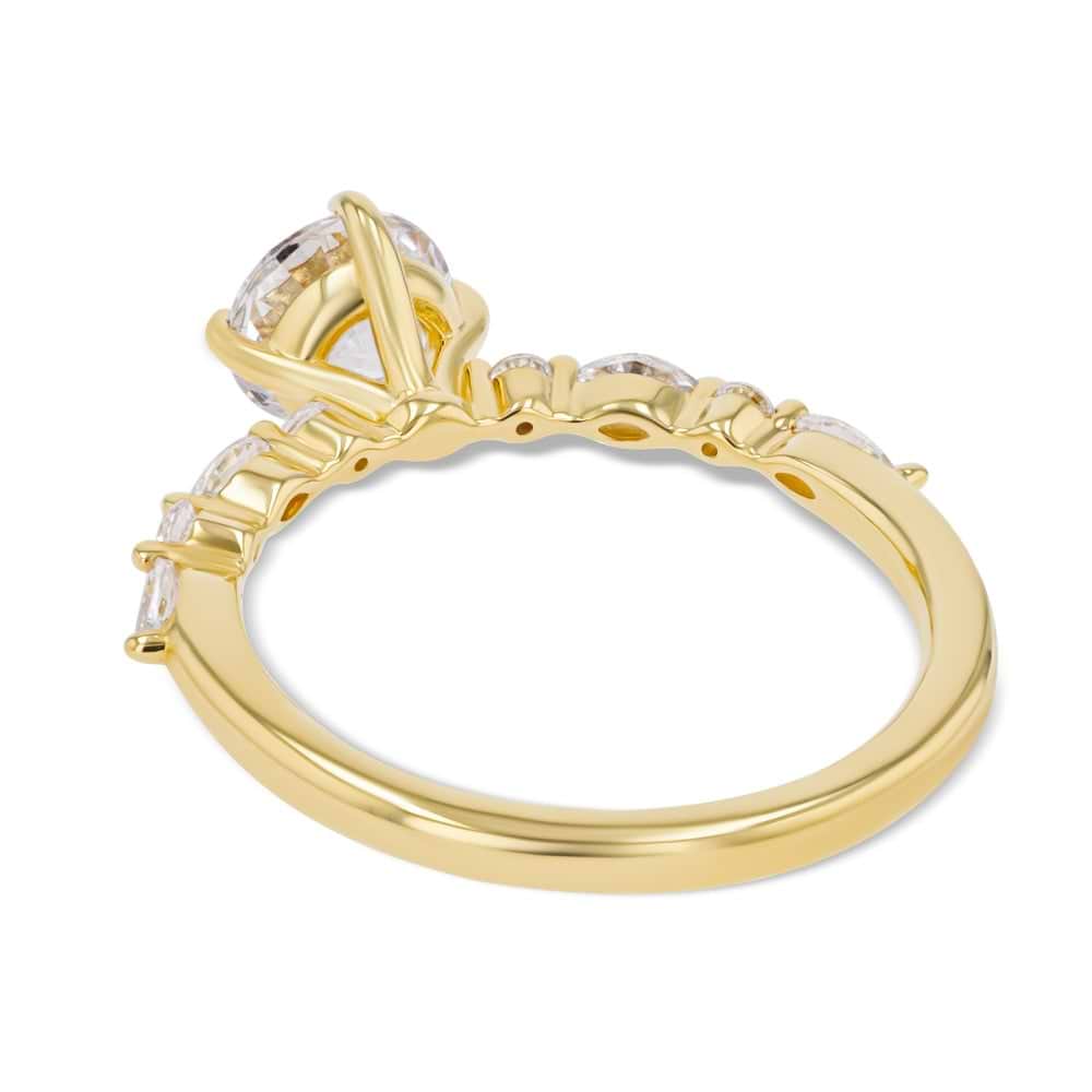 Shown here with a 1.0ct Round Cut center stone in 14K Yellow Gold|summer engagement ring with diamond accenting stones and a round cut center stone set in 14k yellow gold metal