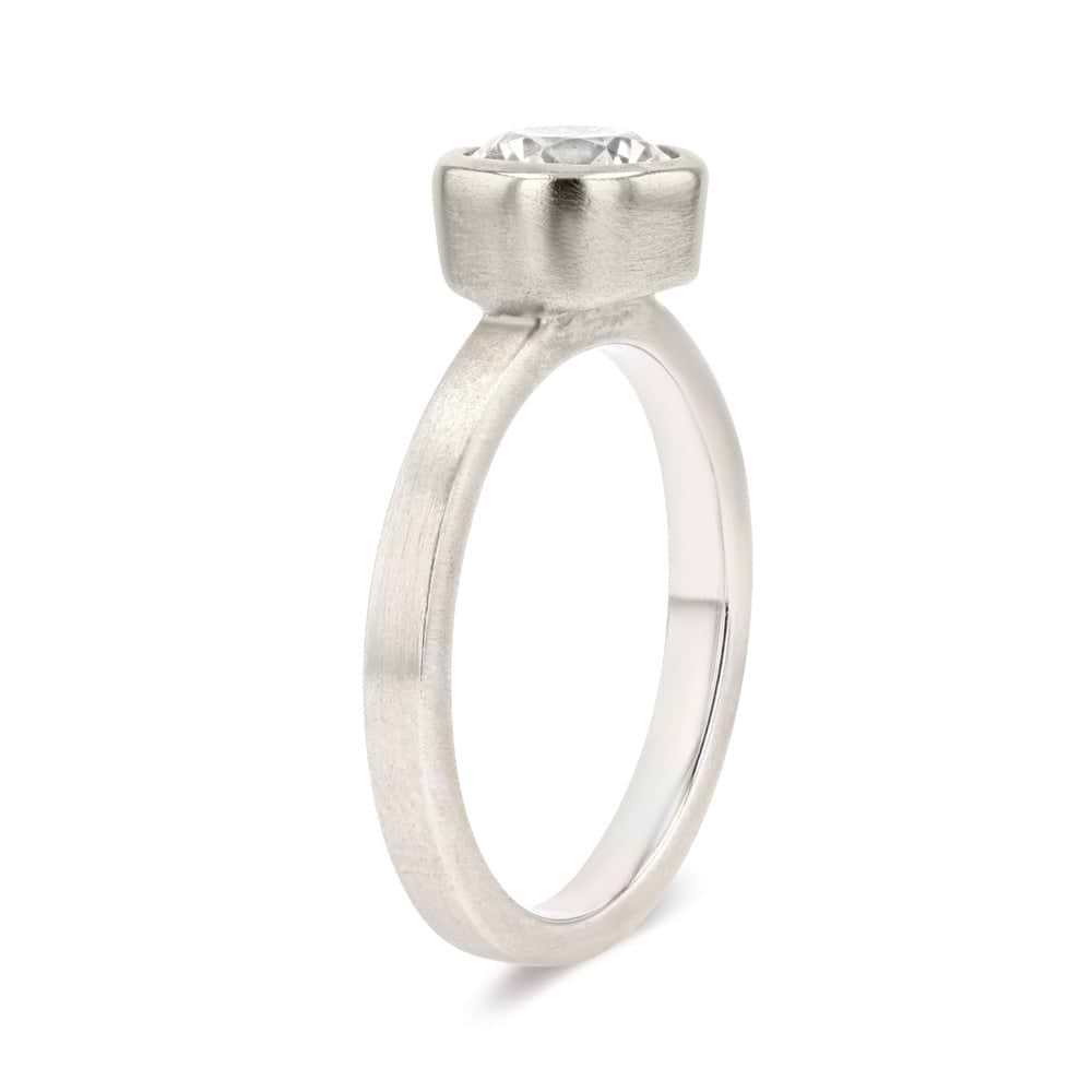 Shown in 14K White Gold with a Satin Finish|bezel set solitaire engagement ring with round cut lab grown diamond in satin finish 14k white gold metal