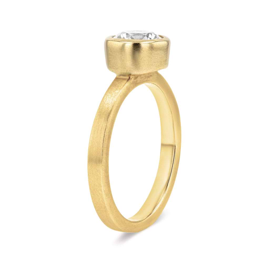 Shown in 14K Yellow Gold with a Satin Finish|bezel set solitaire engagement ring with round cut lab grown diamond in satin finish 14k yellow gold metal
