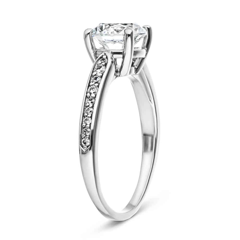 Shown with a 1.0ct Round cut Lab-Grown Diamond with accenting diamonds on the band in recycled 14K white gold 