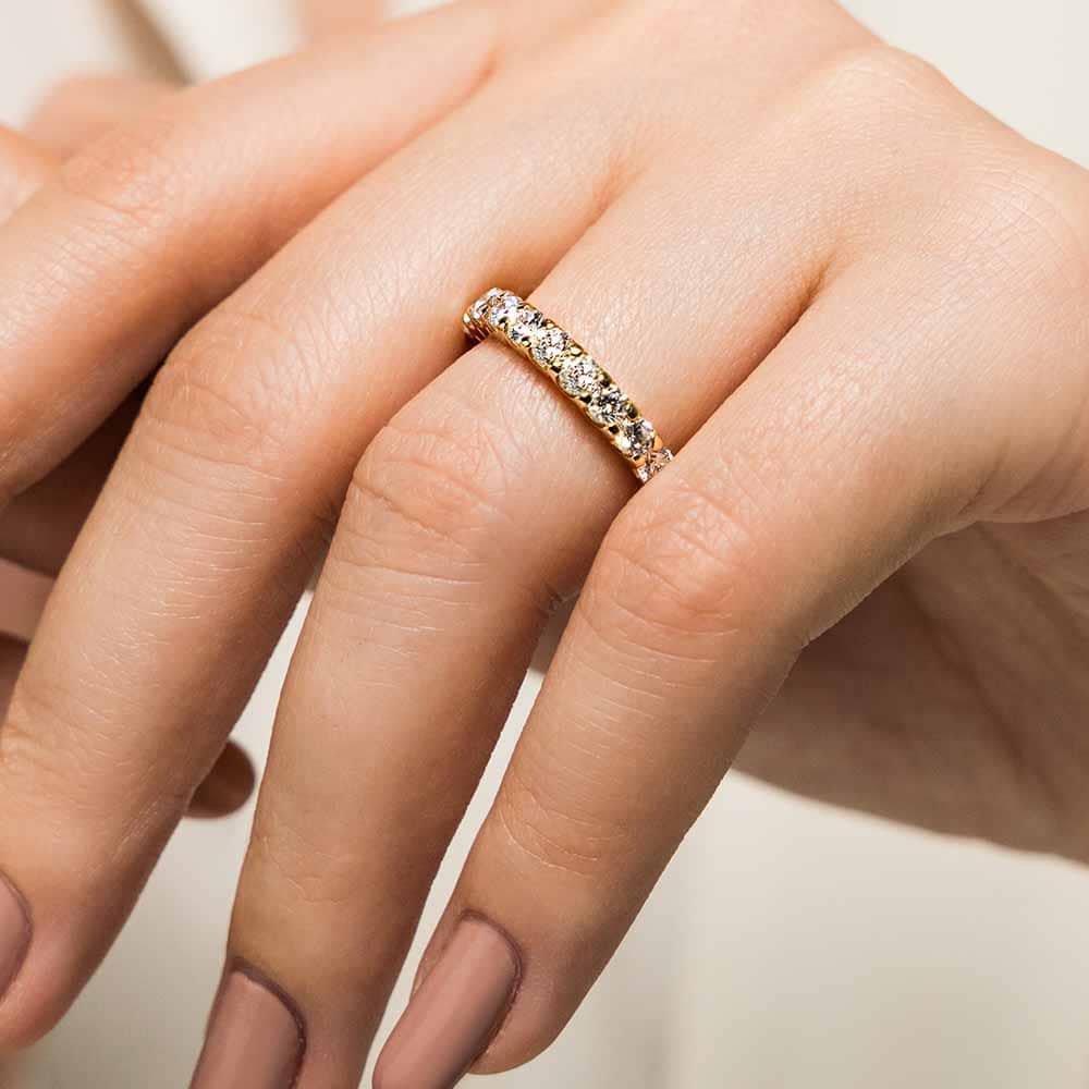 Shown with 1.5ctw Lab Diamonds in 14k Yellow Gold|Diamond accented wedding band with 11 round cut lab grown diamonds set in 14k yellow gold shown worn on hand