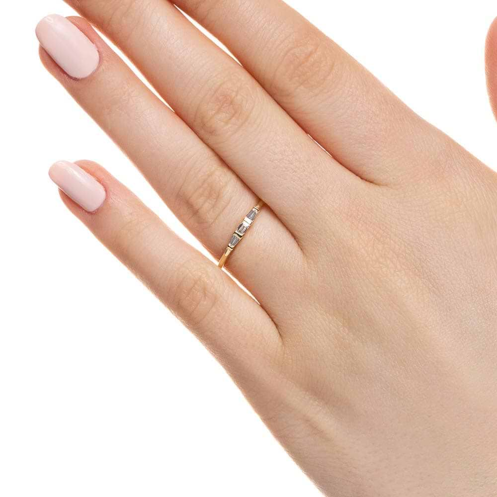 Fashion ring set with three recycled baguette diamonds in recycled 10K yellow gold 