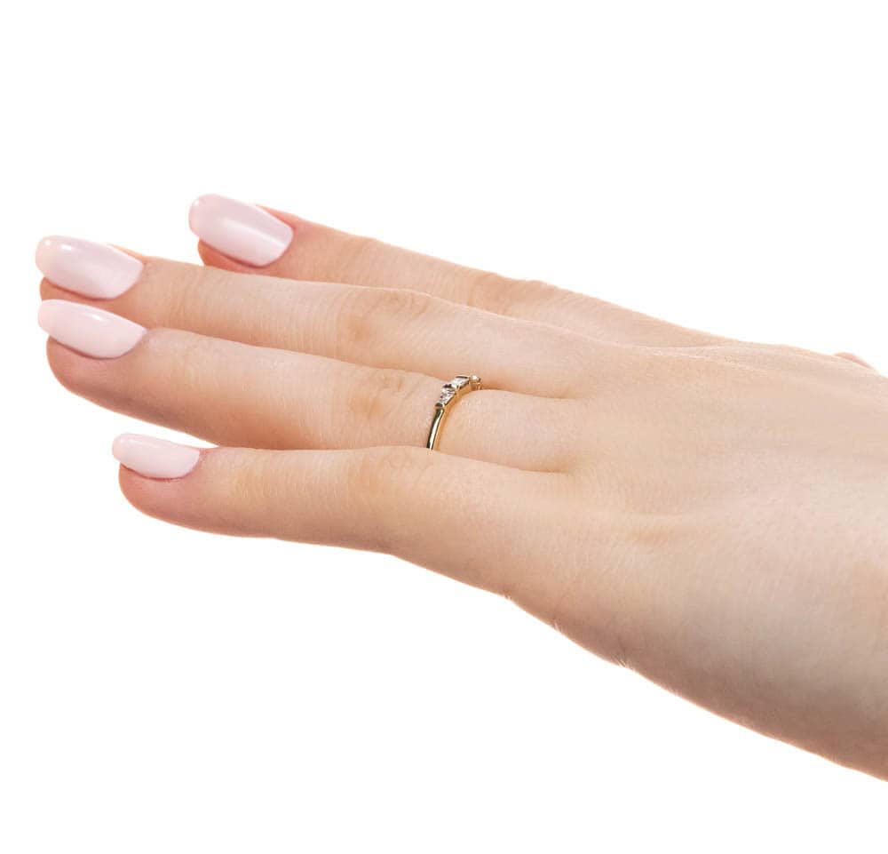 Fashion ring set with three recycled baguette diamonds in recycled 10K yellow gold 