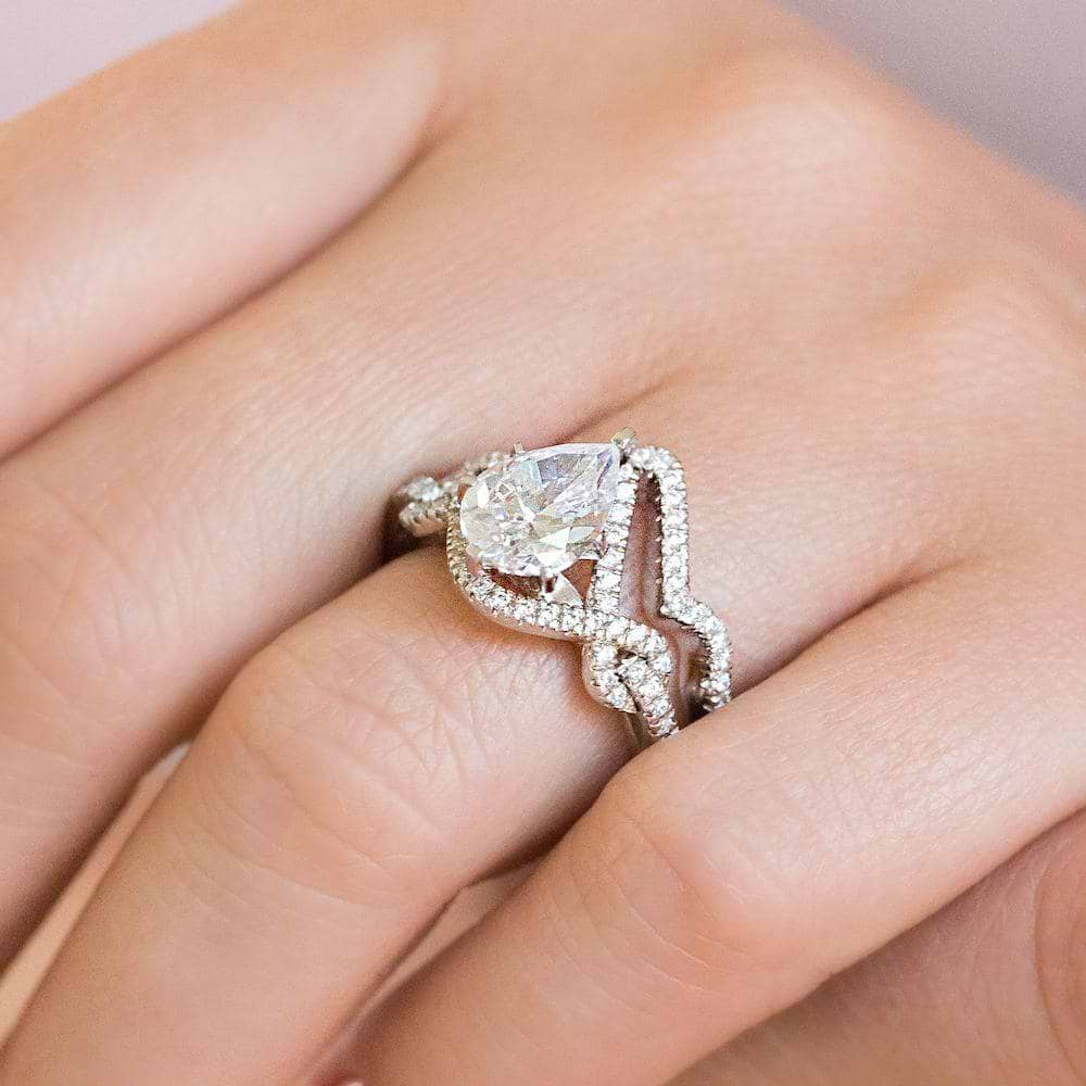 Shown with the Alder matching engagement ring, can be purchased together for a discounted price | two tone wedding set Shown with a 1.0ct Pear cut Lab-Grown Diamond with a diamond accented halo and twisted detail band in recycled 14K white gold with matching wedding band.