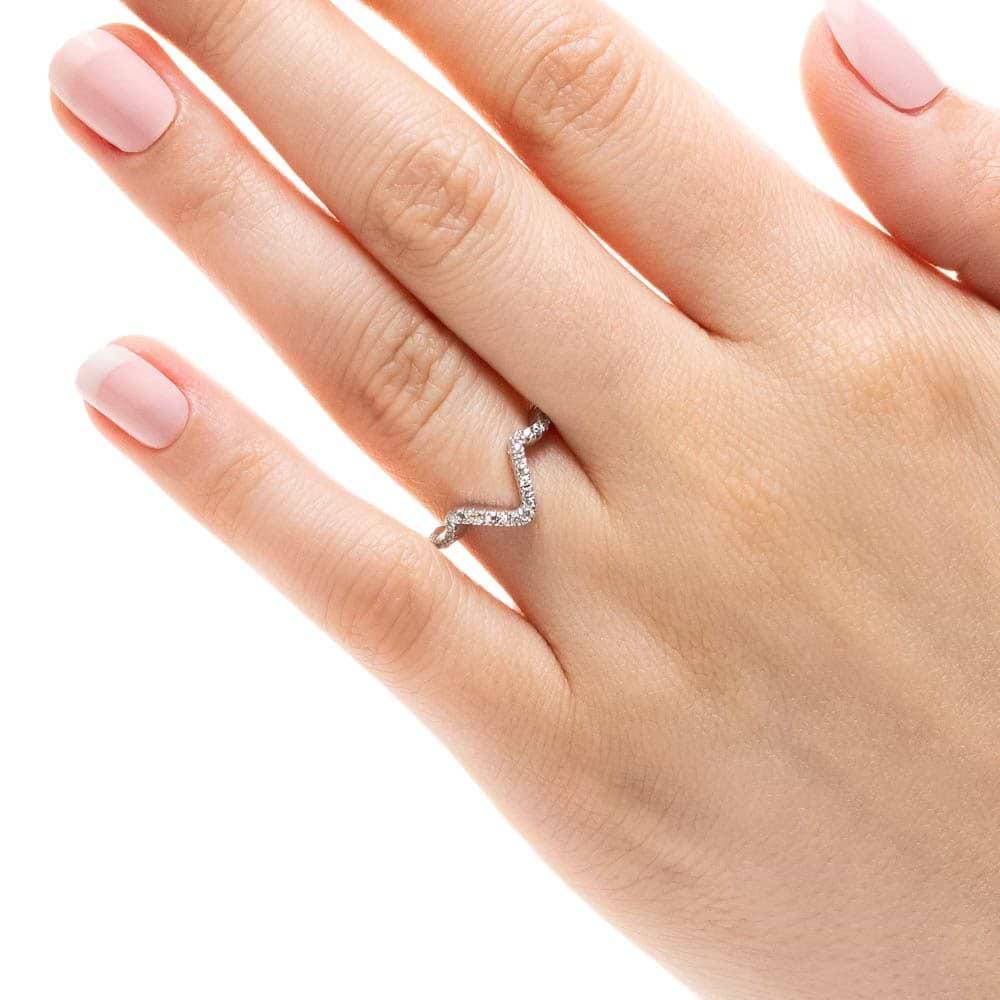 Shown in 14k White Gold|Unique diamond accented wavy v wedding band in 14k white gold shown worn on hand