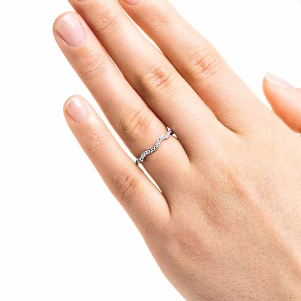 Shown in 14k White Gold|Unique wavy diamond accented wedding band in 14k white gold shown on hand