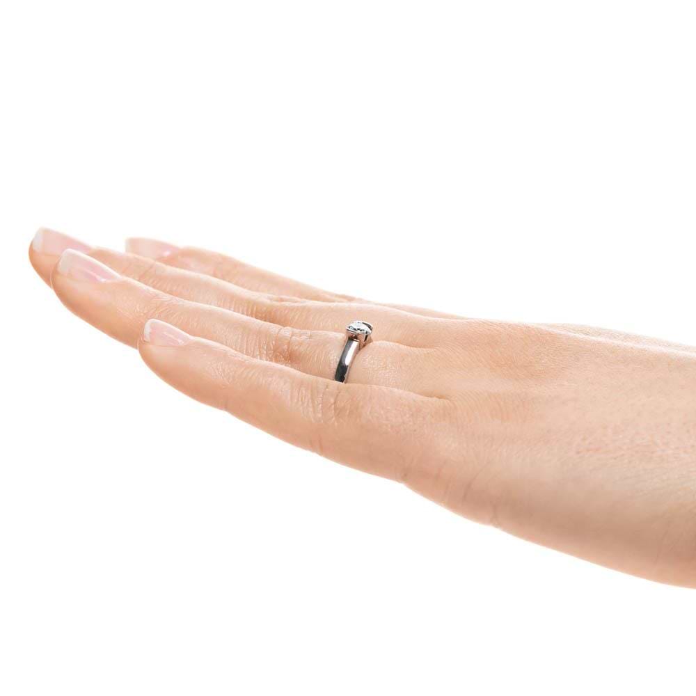 Shown with 1ct Round Cut Lab Grown Diamond in 14k White Gold|Minimalistic modern solitaire engagement ring with 1ct round cut lab grown diamond in 14k white gold worn on hand