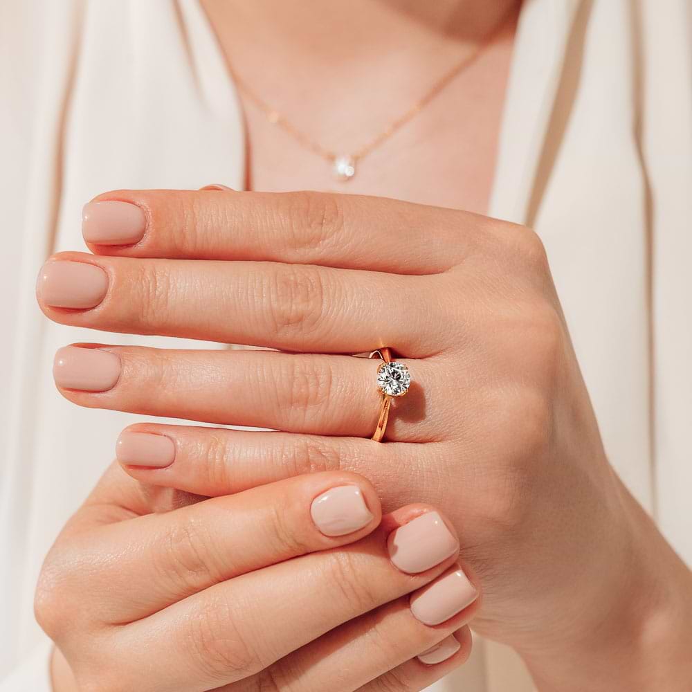 Shown with 1ct Round cut Lab Grown Diamond in 14k Rose Gold|Modern futuristic sci-fi solitaire engagement ring with unique knife edge shank and double prong head holding a 1ct round cut lab created diamond in 14k rose gold