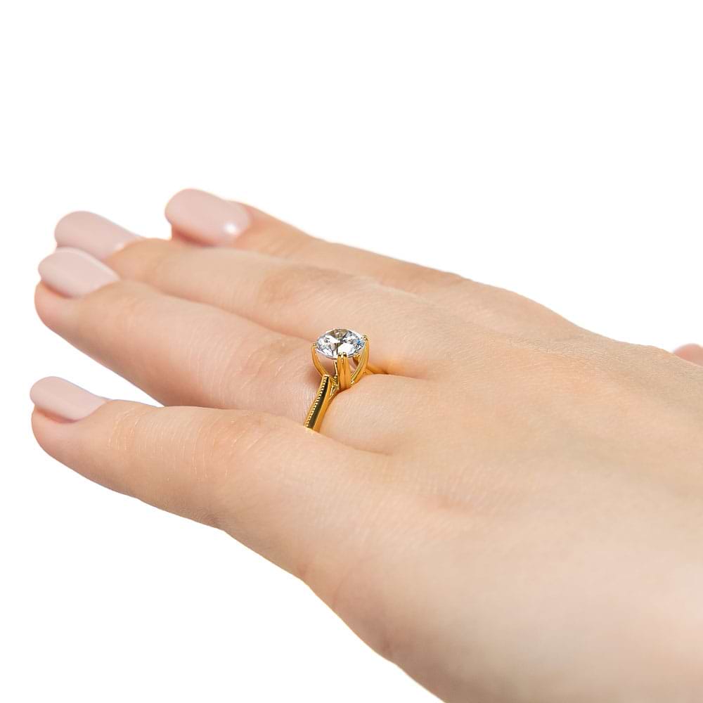 Shown with 1ct Round cut Lab Grown Diamond in 14k Yellow Gold|Modern futuristic sci-fi solitaire engagement ring with unique knife edge shank and double prong head holding a 1ct round cut lab created diamond in 14k yellow gold