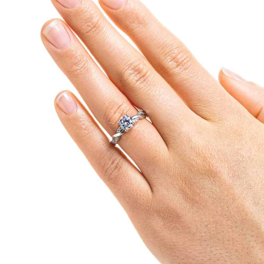 Shown with 1ct Round Cut Lab Grown Diamond in 14k White Gold|Nature inspired engagement ring with twisted diamond accented band featuring 1ct round cut lab grown diamond in 14k white gold worn on hand