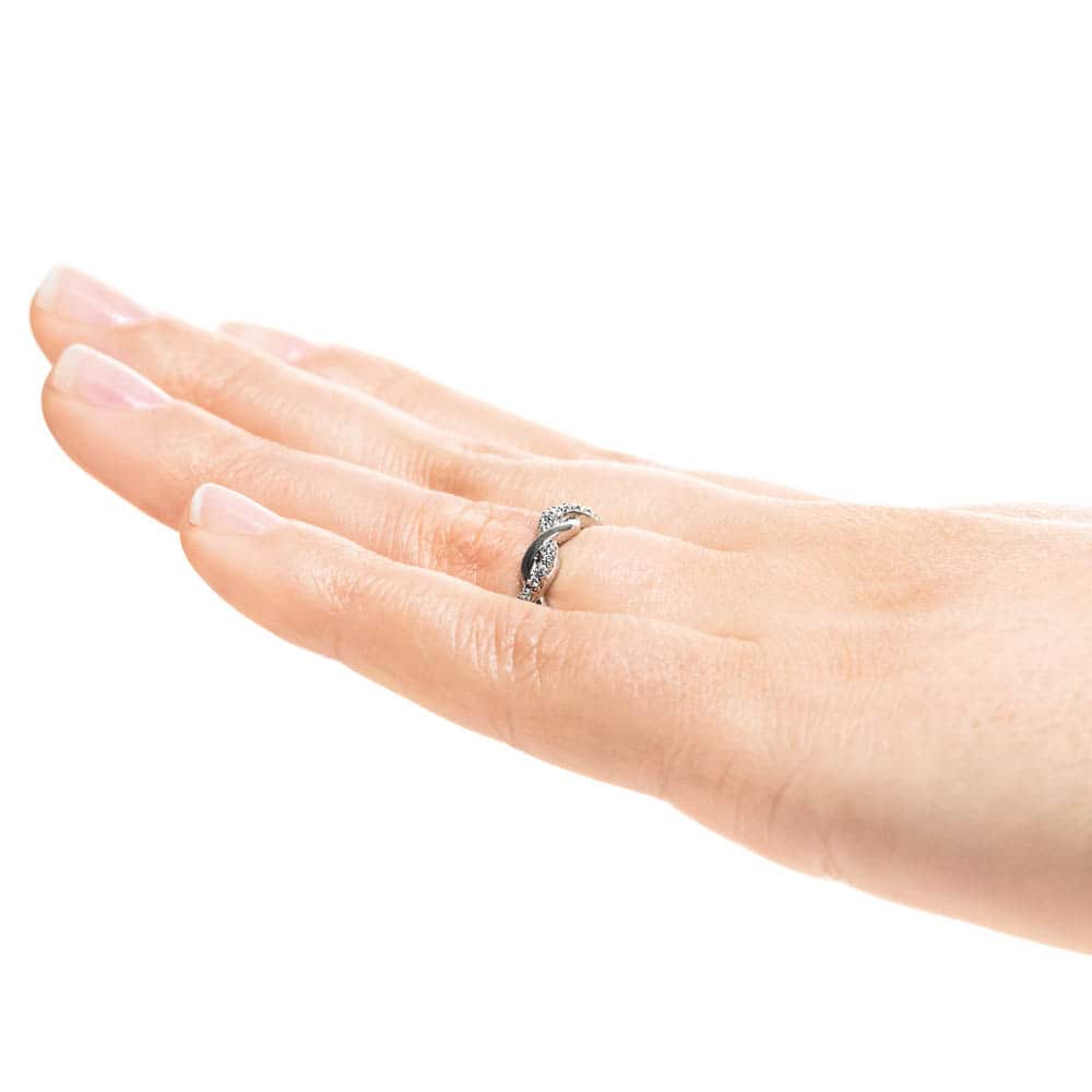 Shown in 14k White Gold|Braided metal design diamond accented wedding band in 14k white gold worn on hand sideview