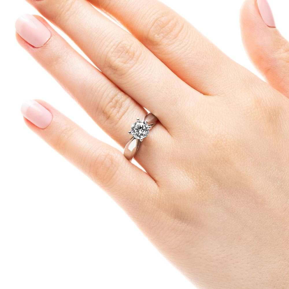Shown with 1ct Round Cut Lab Grown Diamond in Platinum|Modern solitaire engagement ring with wide band and cathedral style design featuring 1ct round cut lab grown diamond in platinum worn on hand