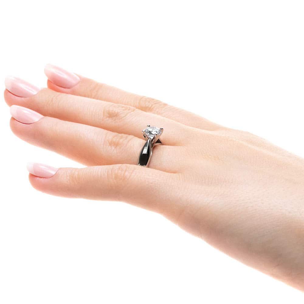 Shown with 1ct Round Cut Lab Grown Diamond in Platinum|Modern solitaire engagement ring with wide band and cathedral style design featuring 1ct round cut lab grown diamond in platinum worn on hand