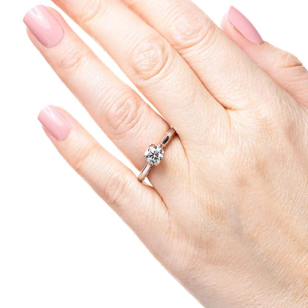 Shown with 1ct Round Cut Lab Grown Diamond in Two Tone 14k White Gold & 14k Rose Gold|Unique two tone solitaire engagement ring with inlay braided rope design set with 1ct round cut lab grown diamond in 14k white gold and rose gold worn on hand