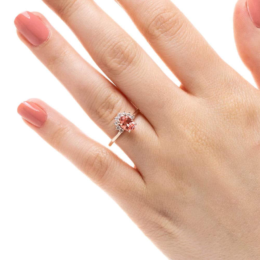 Shown with 1ct Oval Cut Lab Grown Champagne Pink Sapphire in 14k Yellow Gold|Vintage style elegant engagement ring with half halo and a 1ct oval cut lab grown champagne pink sapphire in 14 yellow gold shown worn on hand