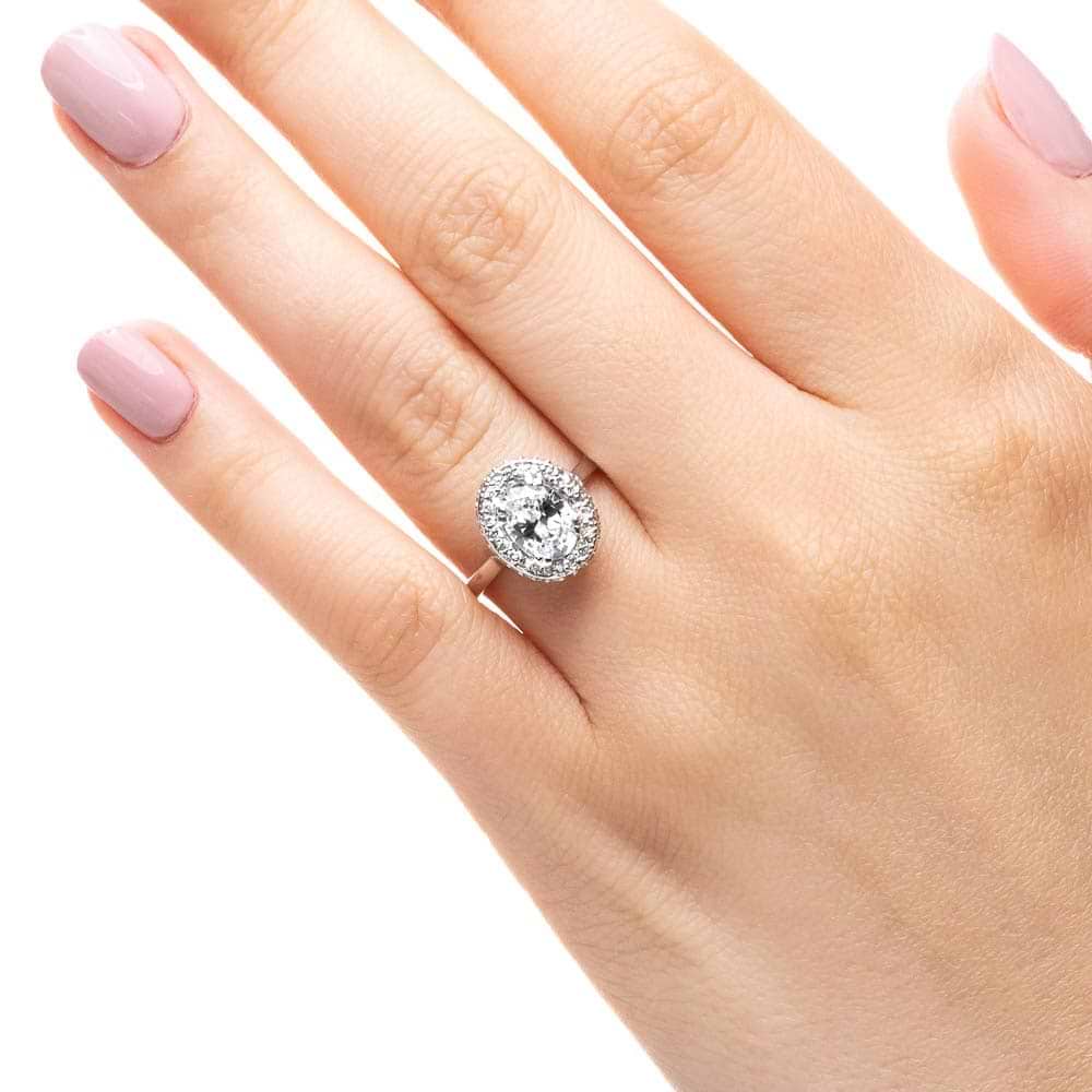Shown with 1ct Oval Cut Lab Grown Diamond in 14k White Gold|Antique style diamond accented halo engagement ring with 1ct oval cut lab grown diamond in 14k white gold shown worn on hand