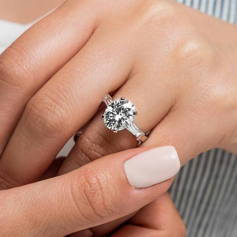 Shown with a 3.0ct Oval cut Lab-Grown Diamond and recycled baguette side stones in recycled 14K white gold | three stone engagement ring Shown with a 3.0ct oval cut Lab-Grown Diamond and recycled baguette side stones in recycled 14K white gold