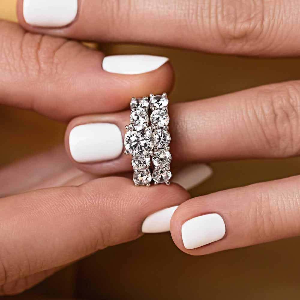 Shown with a 1.0ct Lab-Grown Diamond center stone with 1.0ctw Diamond Hybrid accenting stones in recycled 14K white gold with matching wedding band| matching wedding set Shown with a 1.0ct Lab-Grown Diamond center stone with 1.0ctw Diamond Hybrid accenting stones in recycled 14K white gold with matching wedding band
