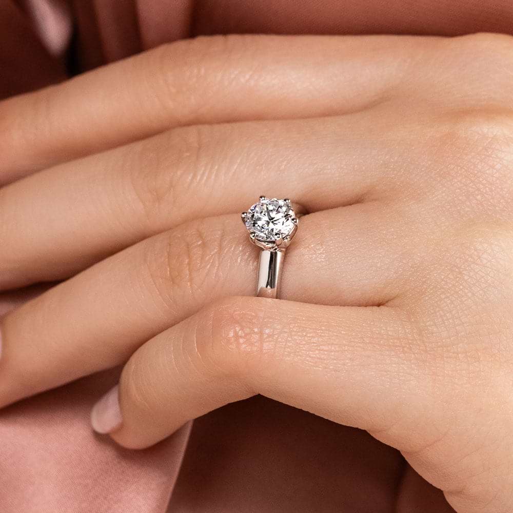 Shown with 1.5ct Round Cut Lab Grown Diamond in 14k White Gold|Beautiful classic solitaire engagement ring with 6 prong head set 1.5ct round cut lab grown diamond in 14k white gold shown worn on hand