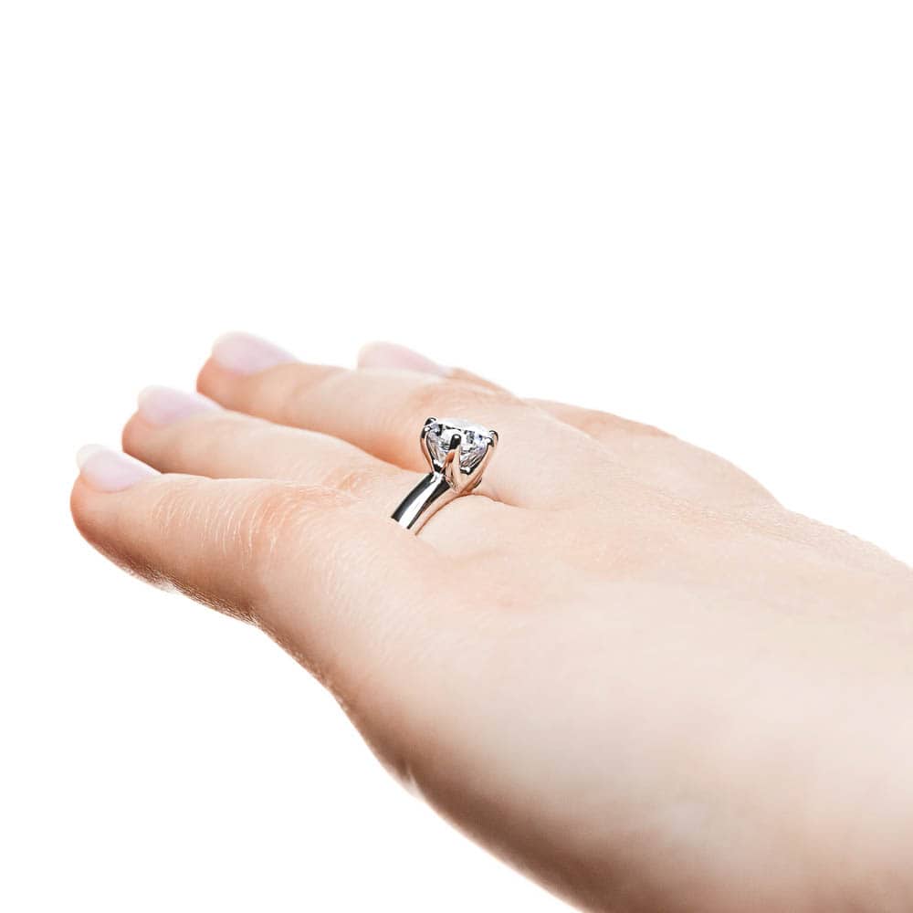 Shown with 1.5ct Round Cut Lab Grown Diamond in 14k White Gold|Solitaire engagement ring with 6 prong head set 1.5ct round cut lab grown diamond in 14k white gold shown worn on hand from side