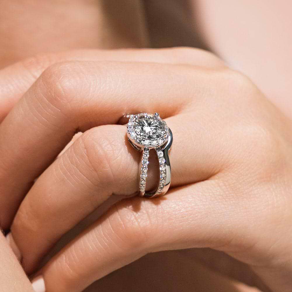 Shown with a 1.0ct Round cut Lab-Grown Diamond with diamond accented halo and split shank in recycled 14K white gold with matching wedding band| diamond accented engagement ring Shown with a 1.0ct Round cut Lab-Grown Diamond with diamond accented halo and split shank in recycled 14K white gold with matching wedding band