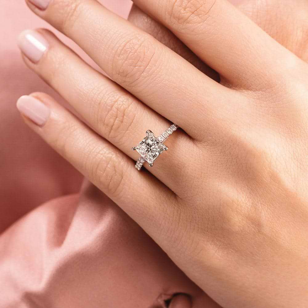 Shown with 1ct Cushion Cut Lab Grown Diamond in Platinum|Diamond accented engagement ring with 1ct cushion cut lab grown diamond set in a four prong trellis in platinum shown worn on hand