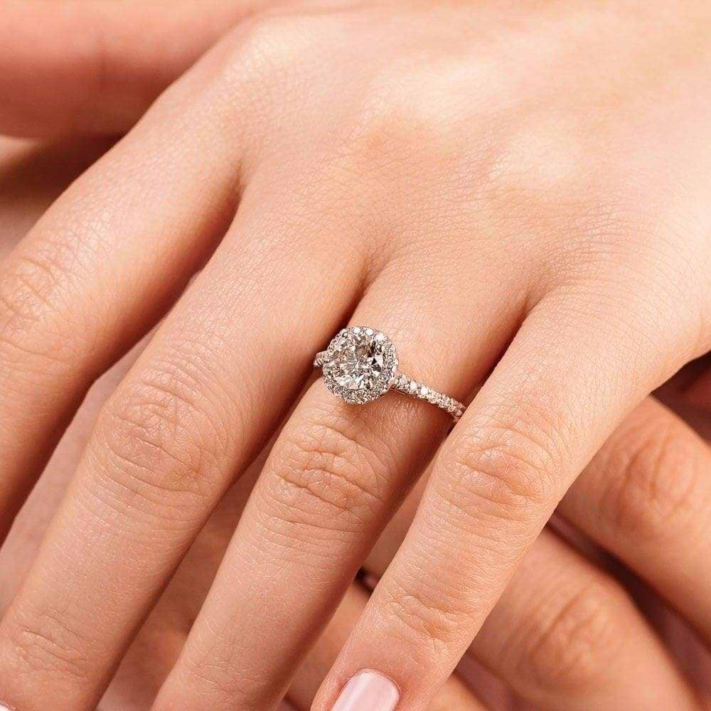 Shown with 2ct Round Cut Lab Grown Diamond in 14k White Gold|Diamond accented halo engagement ring with 2ct round cut lab grown diamond in 14k white gold on hand