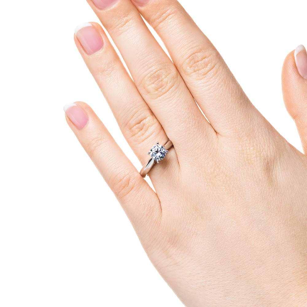 Shown with 1ct Round Cut Lab Grown Diamond in 14k White Gold|Simple solitaire engagement ring with cathedral design holding a 1ct round cut lab grown diamond in 14k white gold shown worn on hand