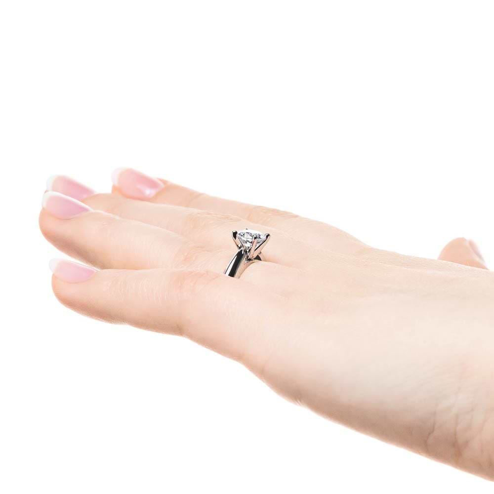 Shown with 1ct Round Cut Lab Grown Diamond in 14k White Gold|Simple solitaire engagement ring with cathedral design holding a 1ct round cut lab grown diamond in 14k white gold shown worn on hand sideview