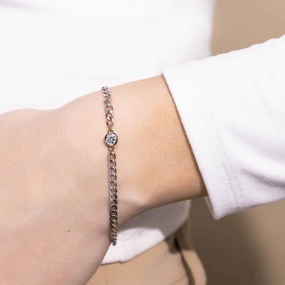 Shown with a bezel-set Lab Grown Diamond in 14K White Gold|Woman wearing Diamond Bezel Curb Chain Bracelet in 14 carat white gold with one Lab Grown Diamond from MiaDonna