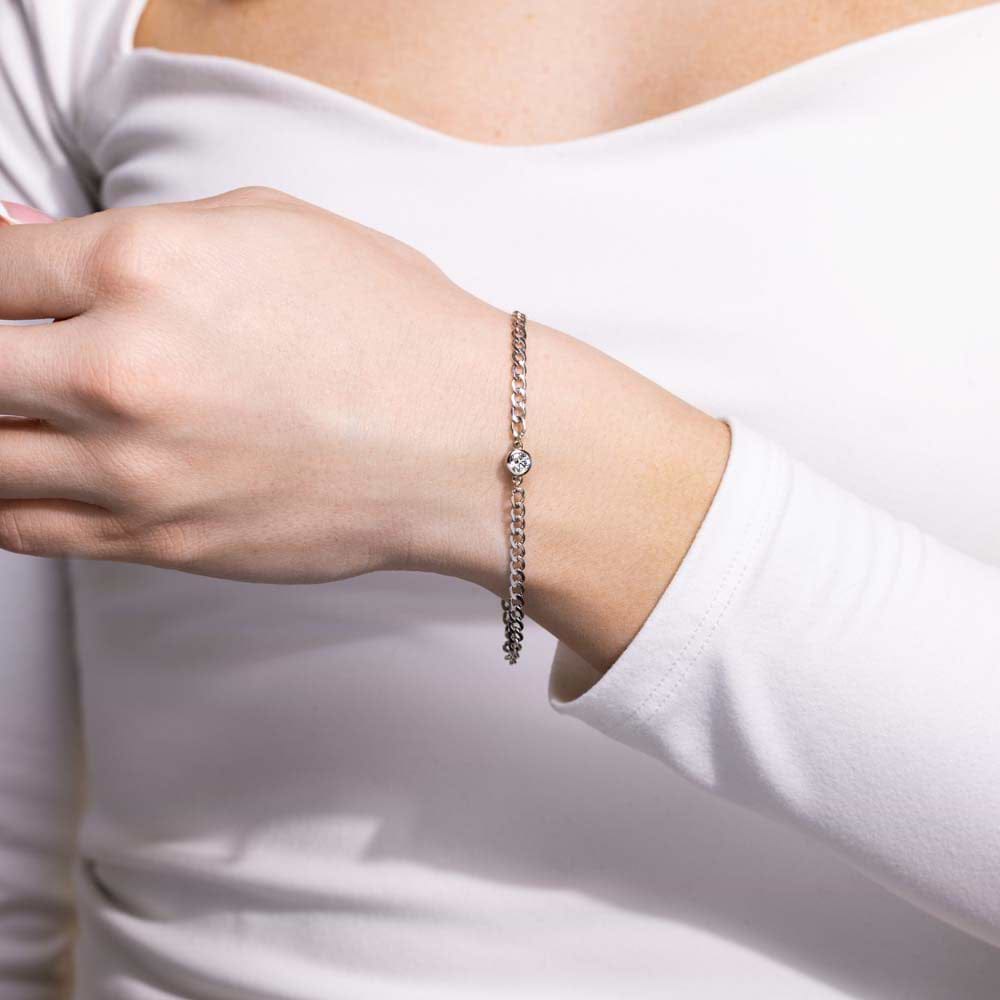 Shown with a bezel-set Lab Grown Diamond in 14K White Gold|Close up of woman wearing Diamond Bezel Curb Chain Bracelet in 14 carat white gold with one Lab Grown Diamond from MiaDonna