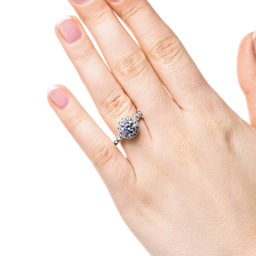 Shown with 1ct Round Cut Lab Grown Diamond in 14k White Gold|Twisted diamond halo engagement ring with a 1ct round cut lab grown diamond in 14k white gold worn on hand