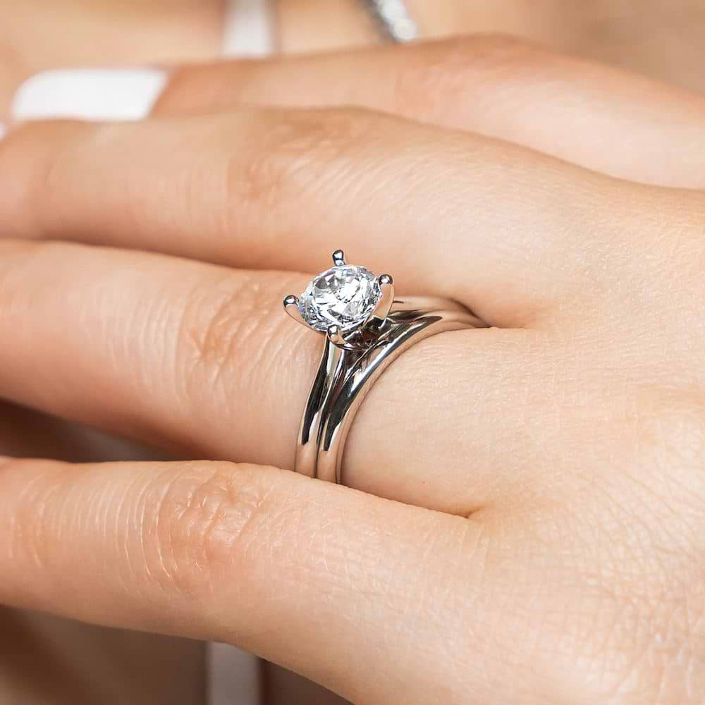 Shown with a 1.0ct Round cut Lab-Grown Diamond in recycled 14K white gold with matching wedding band 