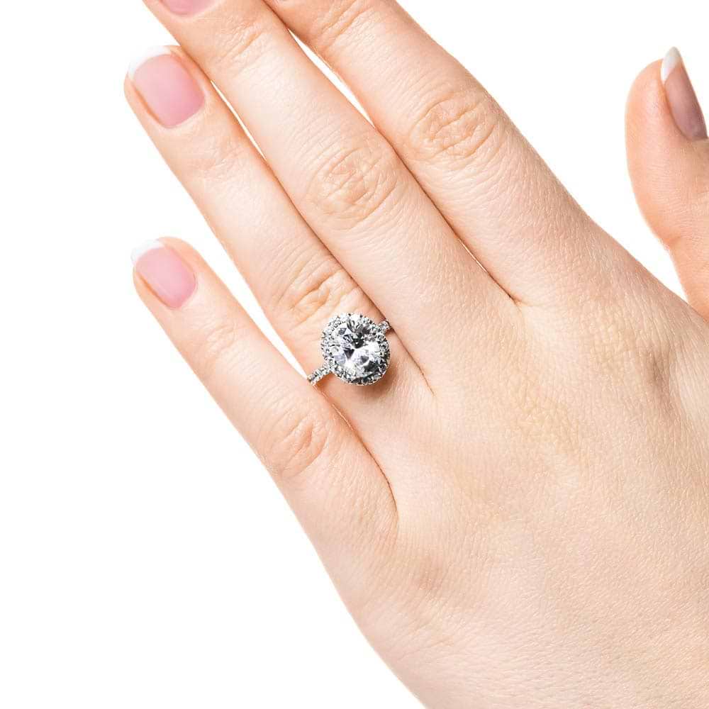 Shown with 1ct Oval Cut Lab Grown Diamond in Platinum|Dream diamond halo engagement ring with diamond accents and a 1ct oval cut lab grown diamond in platinum worn on hand