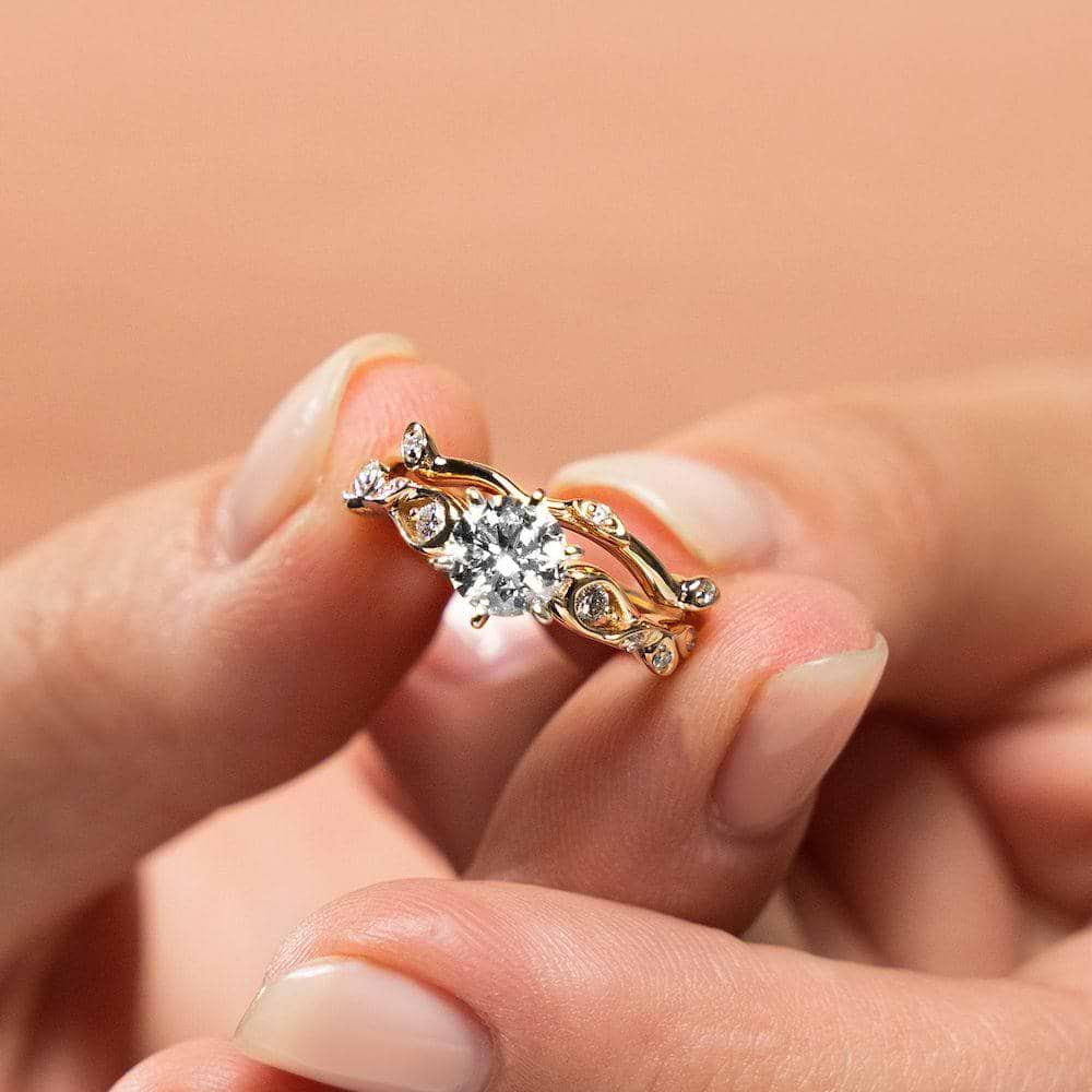 Shown with a 1.0ct Round cut Lab-Grown Diamond with accenting diamonds in recycled 14K yellow gold with matching wedding band | engagement ring leaf detail Shown with a 1.0ct Round cut Lab-Grown Diamond with accenting diamonds in recycled 14K yellow gold with matching band